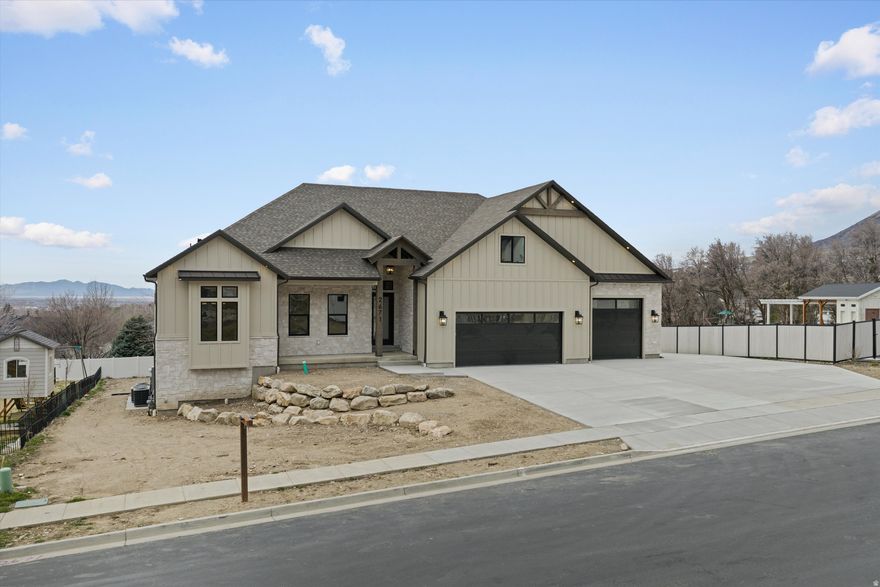 This is the kind of house you only build once. Perched on the North Ogden bench with sweeping views of Ben Lomond Peak and Coldwater Canyon, this fully custom residence was built with a level of intention and craftsmanship rarely seen in today's market. With over 5,300 square feet, 7 bedrooms, 6 bathrooms, 4 laundry rooms, and a 4-car garage, this home offers the space, functionality, and durability of a true forever home. From the moment you walk through the oversized front door, it becomes clear this is not your typical new build. The main living area opens to 13-foot ceilings and a floor-to-ceiling stone fireplace, creating a dramatic yet warm gathering space designed for both everyday living and entertaining. Throughout the home you'll find custom cabinetry, thoughtful architectural details, and a level of finish work that reflects careful planning and attention to detail. The kitchen was designed for people who actually cook and entertain, featuring a 36" industrial range, Caf appliances, custom vent hood, and an oversized pantry with built-in cabinetry for exceptional organization and storage. Comfort and livability were priorities throughout the design. Each level of the home has its own dedicated furnace and AC system (yes 3 complete systems), while dual 50-gallon water heaters with a circulating hot water system ensure consistent performance for a busy household. Convenience was taken even further with washer and dryer hookups on every floor, eliminating the need to carry laundry up and down stairs. The primary suite is a retreat of its own, offering elevated ceilings, a luxurious spa-style bathroom with a wet room and euro glass shower, and a custom designed walk-in closet the size of a typical bedroom. The fully finished walkout basement expands the home's versatility with two additional bedrooms (one with its own ensuite), living space, and a dedicated home gym. A thoughtfully designed ADU studio with its own entrance, kitchen, and bathroom provides flexible living arrangements for guests, family, home business, or potential rental use. Outside, the attention to quality continues. The home features a durable Hardie board and stone exterior, rough-cut exposed beams, and a covered rear deck positioned to take full advantage of the panoramic mountain and valley views. The property was also designed with future possibilities in mind. It includes 400-amp electrical service, a pre-installed exterior sub-panel for a future shop or pool, EV charging in the garage, hot tub wiring on the rear patio, and a 44-foot RV pad with additional off-street parking for an ADU, home business, or future expansion. Located just minutes from trailheads, world-class skiing, and the outdoor recreation that makes Northern Utah special, this home offers the rare combination of custom craftsmanship, modern convenience, and mountain lifestyle living. Simply put, this is what happens when someone builds your forever home. Homes built with this level of care, quality, and foresight rarely come available.