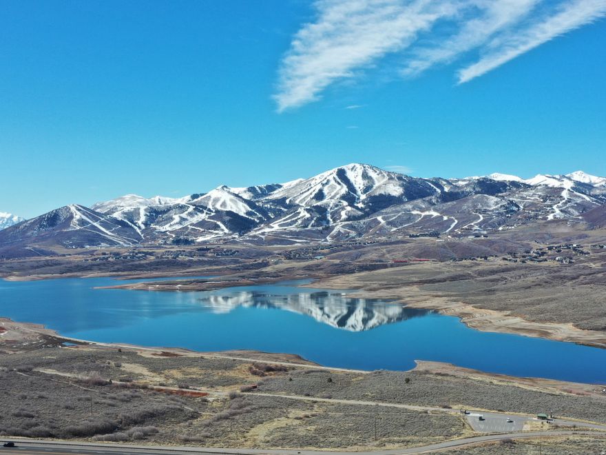 Stunning Views of Deer Valley, Jordanelle and Timpanogos in Tranquil Setting.  Welcome to your oasis of luxury in the heart of Deer Mountain, an exclusive community that offers breathtaking views of the Deer Valley Ski Resort & the Jordanelle. Wake up to views of snow-capped peaks & discover the ultimate retreat with this exquisite 4 BR / 3 BA home.  The open-plan living area is anchored by a wood-burning, stone fireplace and vaulted ceilings.  This beautiful home offers single level living with a kitchen, dining area, great room, primary bedroom with ensuite bathroom, secondary bedroom, bathroom, & laundry room on the main floor. The kitchen features Wolf & Sub-Zero appliances, solid white oak wood flooring throughout the home that seamlessly transitions into travertine bathrooms.  The lower, walkout level has a separate entrance, gas stone fireplace, wet bar, great room, 2 bedrooms, & a bathroom. Step into the backyard & discover your own private sanctuary: complete with a hot tub, stone patio & walkways perfect for entertaining & unwinding in nature.  As an added bonus, the 2 car garage has a Tesla charging station & lots of storage.  This home was remodeled in mid-2022 with a new roof, HVAC System, kitchen with quartzite countertops, deck, tankless water heater, central vacuum, flooring, fireplaces, electric shades on main level & many more upgrades too numerous to mention (see detailed improvement list).  Just minutes from world-class skiing at Deer Valley and PCMR, as well as historic Main Street dining & entertainment. The Jordanelle offers boating, paddle boarding, fishing, & waterfront fun, while hiking & biking trails connect you.   Don't miss this opportunity to own a piece of paradise located in the established & highly sought after Deer Mountain neighborhood (not surrounded by continuous construction) with low HOA & transfer fees.  See video of Deer Mountain Community and a Walkthrough Matterport Tour.    All information herein is deemed reliable but is not guaranteed. Buyer is responsible for verifying all listing information, including square feet/acreage, to the buyer's own satisfaction. See Exclusion List.