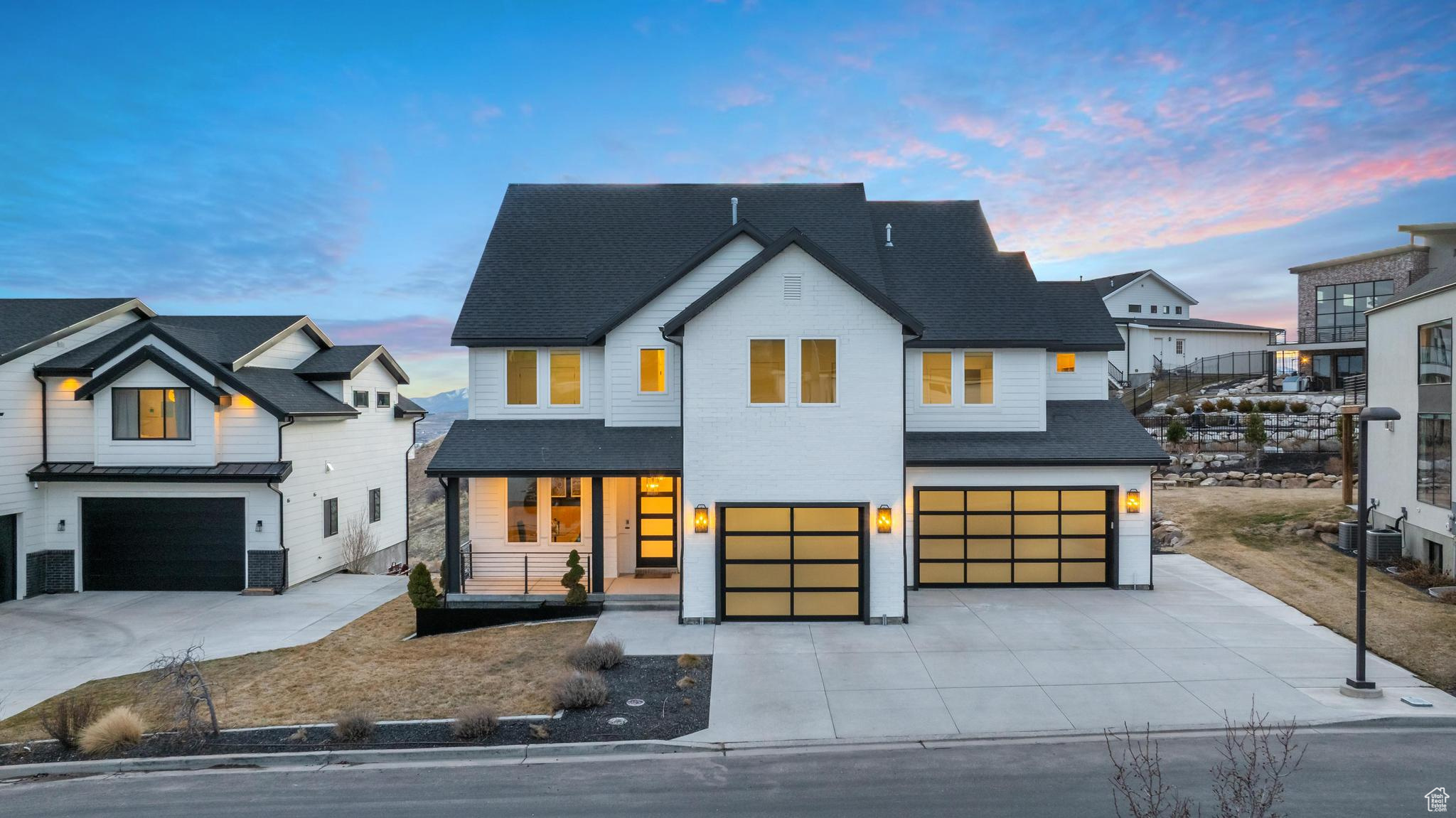 This fully reimagined luxury home in Vialetto has undergone a top-to-bottom remodel, transforming it into a custom masterpiece. Every detail has been elevated, from the all-new high-end Thermador appliances (besides the fridge) to the custom white oak cabinetry, Taj Mahal quartzite countertops, and fluted Tambour woodwork. Step inside to soaring double-height ceilings, a floating staircase, and a striking custom metal staircase that makes a bold architectural statement. The main level features an open-concept gourmet kitchen with LED-lit cabinetry, an oversized fireplace with a semi-metallic plaster wall and black oak floating shelves, and a rare 3-car garage with a suspended slab. Upstairs, the primary suite offers a private deck with breathtaking views, a custom white oak slat-paneled wall with alabaster marble lighting, and a spa-like bath with new fixtures and under-cabinet LED lighting. The custom-built primary closet boasts 16 built-in drawers and LED accent lighting. The lower level is designed for entertainment and function, featuring a guest suite with a full bath, a home office, a spacious playroom, a gym, and a private theater room with panel accents and pre-wiring for a projector and surround sound. Outside, the expansive backyard offers a peaceful retreat for relaxation or entertaining. With all-new paint inside and out, designer fixtures, and luxury finishes throughout, this home blends modern sophistication with architectural excellence. Don't miss your chance to own this one-of-a-kind custom remodel-schedule your private tour today!