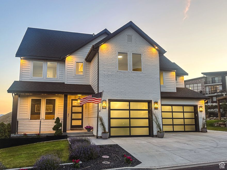 This fully reimagined luxury home in Vialetto has undergone a top-to-bottom remodel, transforming it into a custom masterpiece. Every detail has been elevated, from the all-new high-end Thermador appliances (besides the fridge) to the custom white oak cabinetry, Taj Mahal quartzite countertops, and fluted Tambour woodwork. Step inside to soaring double-height ceilings, a floating staircase, and a striking custom metal staircase that makes a bold architectural statement. The main level features an open-concept gourmet kitchen with LED-lit cabinetry, an oversized fireplace with a semi-metallic plaster wall and black oak floating shelves, and a rare 3-car garage with a suspended slab. Upstairs, the primary suite offers a private deck with breathtaking views, a custom white oak slat-paneled wall with alabaster marble lighting, and a spa-like bath with new fixtures and under-cabinet LED lighting. The custom-built primary closet boasts 16 built-in drawers and LED accent lighting. The lower level is designed for entertainment and function, featuring a guest suite with a full bath, a home office, a spacious playroom, a gym, and a private theater room with panel accents and pre-wiring for a projector and surround sound. Outside, the expansive backyard offers a peaceful retreat for relaxation or entertaining. With all-new paint inside and out, designer fixtures, and luxury finishes throughout, this home blends modern sophistication with architectural excellence. Don't miss your chance to own this one-of-a-kind custom remodel-schedule your private tour today!