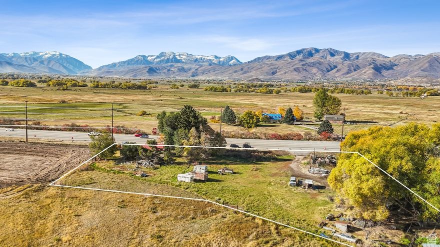 HWY 40 Frontage 2.58-acre High Density Commercial/Res. Development Parcel  Located just off of the Heber/Midway Valley's main artery-Hwy 40-in Wasatch County's burgeoning North Village Overlay District (NVOD), this property offers 2.58 acres of prime visibility, accessibility, with high-density commercial and residential development potential. The site presents a unique opportunity for developers and investors seeking a strategic location with major arterial and collector road access in the Park City periphery. Density under the NVOD Town Core transect district (TC/T5) is 6 ERUs per net acre, the highest density allocated within the NVOD. Nearby amenities, extensive surrounding rooftops to support commercial, and proximity to Deer Valley's new East Village base area make this a strong development candidate or long-term hold. The site also features fantastic views of Mount Timpanogos and surrounding peaks, easy access to major utilities, and direct Heber City adjacency. Don't miss this chance to own a piece of commercial real estate in the rapidly growing Heber Valley.
