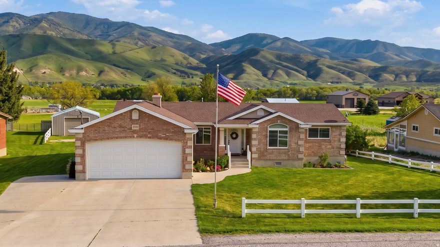Tucked into one of Utah's most breathtaking settings, this cozy and comfortable home offers privacy, space, and views that truly have to be seen to be appreciated. Situated on over an acre, the property gives you endless opportunities to spread out, relax, garden, entertain, or simply enjoy the peaceful surroundings. The updated kitchen blends modern touches with the warmth and character of the home, creating an inviting space for everyday living. Outside, you'll find incredible valley and mountain views, mature fruit trees, and a barn/shop perfect for hobbies, storage, animals, or additional workspace. Roof new in June 2019. AC unit is new. All new windows. Furnace has been rebuilt. Home has permanent lighting. 240 Watt power for electric Vehicle in the garage. Secondary Water - (Dalton Creek). Shop is approximately 1600 sq ft. 25'x60"