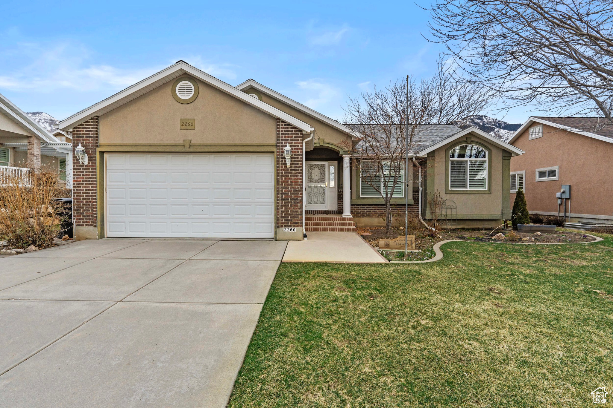 Nestled in a highly sought-after North Ogden neighborhood, this well-maintained rambler offers the perfect blend of comfort and convenience. While located in a 55+ community, current availability allows buyers of all ages to enjoy the lifestyle this serene neighborhood provides. Step inside to a bright and open living space, complete with two cozy fireplaces, ideal for relaxing on chilly evenings. The open layout ensures seamless flow between the living, dining, and kitchen areas, creating a warm and inviting atmosphere. Enjoy the outdoors year-round on the covered deck, perfect for morning coffee or evening gatherings. Designed for low-maintenance living, this home is an excellent choice for those looking to slow down without compromising on comfort.