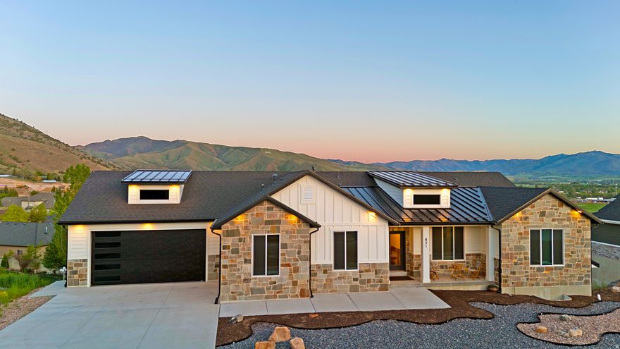 --- 4.6% Loan available with Lender Credits 2/1 buydown. Contact Pete Thomson for info. ----      Perched perfectly to capture breathtaking mountain and valley views, this barely lived-in custom home offers a rare combination of luxury, privacy, and modern design. From the moment you arrive, the stunning curb appeal, elevated setting, and unobstructed scenery set this home apart. Inside, soaring ceilings throughout (9' on the main level and 10' in the basement) create an open, light-filled feel that perfectly complements the expansive views from nearly every angle. The beautifully designed kitchen features waterfall countertops, custom cabinetry, a large walk-in pantry, designer lighting, and high-end finishes throughout. The spacious primary suite was designed to feel like a private retreat with a spa-inspired bathroom featuring a freestanding soaking tub, oversized walk-in shower, dual vanities, and elevated modern finishes. The fully finished basement provides incredible flexibility with space for a home gym, theater room, game room, craft room, or additional entertaining area. The oversized 3-car garage offers ample room for vehicles, storage, and toys. Step outside and enjoy unmatched privacy with no homes directly behind you and panoramic mountain and valley views that are almost impossible to find. Whether you're relaxing on the covered deck, entertaining guests, or simply enjoying the peace and quiet, this home was designed to maximize both comfort and scenery. This is luxury mountain living at its best - without sacrificing convenience or functionality. Don't miss this rare opportunity.