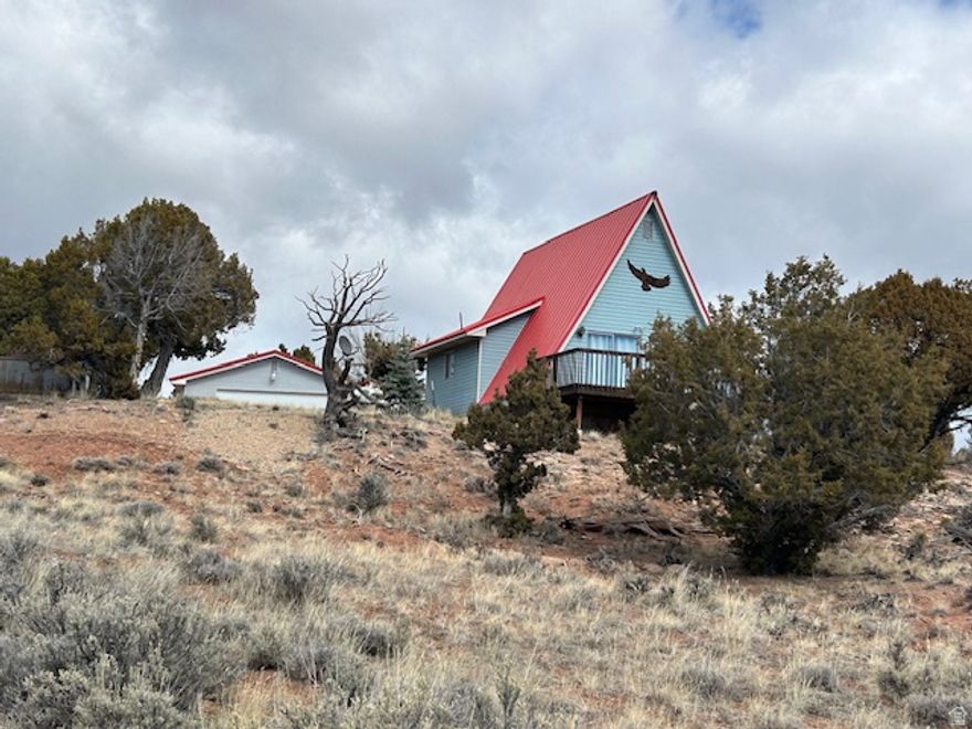 Small cabin on Bandanna Ranch, with city water, power and year 'round access. Cabin has 1 bedroom with an open loft. Sits of 5 private acres, with a large 2 car garage. Cabin sells mostly furnished. Located 1  hrs from the Wasatch front. Boat is included with full price offer.