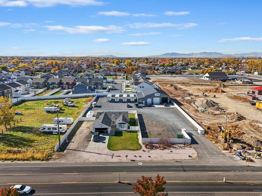 Discover an exceptional investment opportunity in rapidly growing West Haven. For sale, the warehouse and residential home sit on approximately 1.03 acres. Zoned West Haven City C-2, this versatile site offers a modern, well-maintained 3,000 square foot warehouse featuring three overhead doors, high ceilings, and an open floor plan, ideal for a range of business needs. An additional attached 500 square foot accessory warehouse with its own overhead door provides even more storage and operational flexibility. The 840 square foot office area includes several private offices, a welcoming reception space, and plenty of natural light, creating a productive and comfortable workspace. Outside, a large, fenced storage yard enhances security and accommodates equipment or inventory. Conveniently located near major roads and freeway access, the property ensures easy transportation and logistics. The residential home, currently leased through January 31, 2026, boasts 1,734 square feet with two bedrooms, two bathrooms, a two-car garage, and an office that can easily convert to a third bedroom. The fully fenced yard offers privacy and outdoor enjoyment. This property presents a unique opportunity for buyers and investors seeking a well-equipped, multi-use space in a prime location. This property is to be sold whole including warehouse and home and will not be divided.