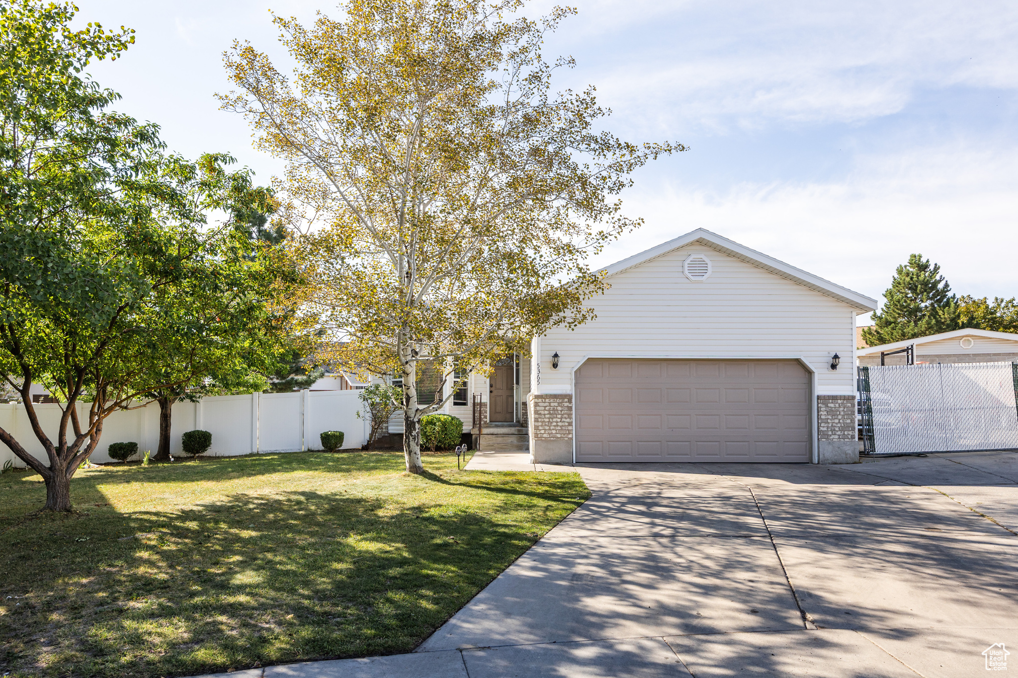 This lovely Kearns home-perched in a cul-de-sac that lends a bit of privacy in an established and tree-lined neighborhood-is bringing a good deal of charm and plenty of desirable features to the table. A somewhat traditional layout is complemented by high ceilings and an abundance of natural light throughout, making it feel even more spacious than its 2100 square feet. The kitchen is spacious and well laid-out-connected seamlessly to the back yard via a set of sliding glass doors, a small deck provides the setting for BBQs or dinners al fresco. With 5 bedrooms and 3 bathrooms, this is a home with room for everyone, and the lower level feels open and bright, thanks in part to large window wells-down here, you'll find a large living area, two of the aforementioned bedrooms, and a dedicated laundry room. The back yard is brimming with potential: plenty of lawn space and a pair of garden boxes lend themselves to fresh veggies and easy gatherings. A gated pad just next to the garage also means you've got room for your RV or boat. The best part? This area offers plenty of parks nearby, and the home is within walking distance of both the Kearns Olympic Oval and the Kearns Oquirrh Park Fitness Center. Translation: the good life is waiting for you on Alpine Flower Circle.