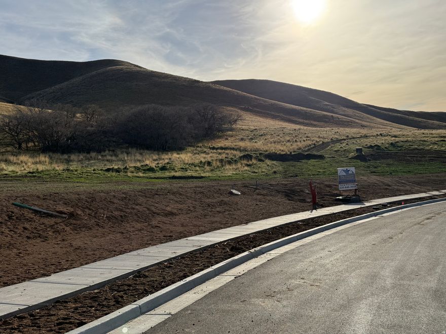 Big Dreams Development is proud to offer this fully improved State Of The Art view Lot. This lot has full city approved tax Id to start building your dream home. Yes this lot has all utilities, tooele city water connection, etc. Sellers are custom builders. Buyers have the option to have sellers build a new custom home on this lot for them. We have very affordable preferred 0$ construction loans with permanent financing available. No Hoa, Amazing foothill, mountain, city & lake views.