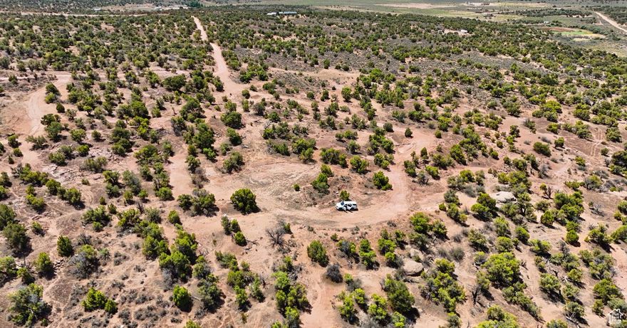 Level lot with great views and easy access off a maintained dirt road. Ideal for camping, recreation, or future development. Water rights for well drilling included. Power is nearby, and both water and power hookups are available at buyer's expense.