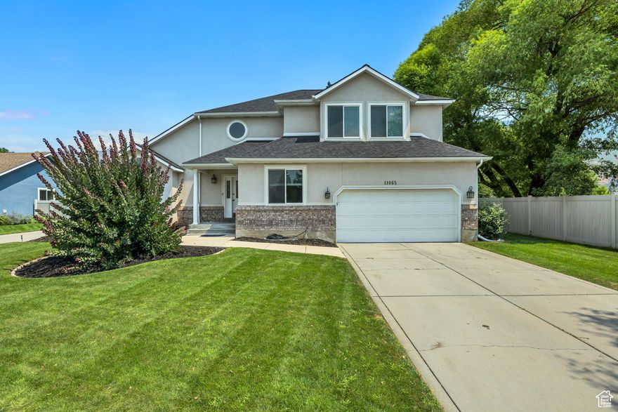 Nestled in a desirable Sandy neighborhood, this exceptional home offers the perfect blend of elegance and convenience with swift access to the highway and shopping. Boasting significant recent upgrades including a new HVAC system (2018), a new roof, new windows, and solar panels for lower energy bills, this home is as efficient as it is beautiful. A grand entry welcomes you with soaring vaulted ceilings and gleaming LVP floors, complemented by newer carpet throughout. This 4-bedroom, 3-bathroom home, situated on a large lot with a 3-car garage featuring overhead storage, is designed for modern living. The main floor features a dedicated office, formal sitting and dining rooms, and a spacious kitchen equipped with new appliances, a stylish backsplash, a convenient built-in desk, and a pantry. This culinary space flows seamlessly into a large family room, made cozy by a warm fireplace. A half bath completes the main level. Upstairs, the expansive master suite serves as a private retreat, offering a separate shower and tub, and a generous walk-in closet. You will also find a convenient laundry room with built-in cabinets and two additional bedrooms. The partially finished basement provides valuable extra space with a fourth bedroom, a second family room, and ample room for storage and future growth.