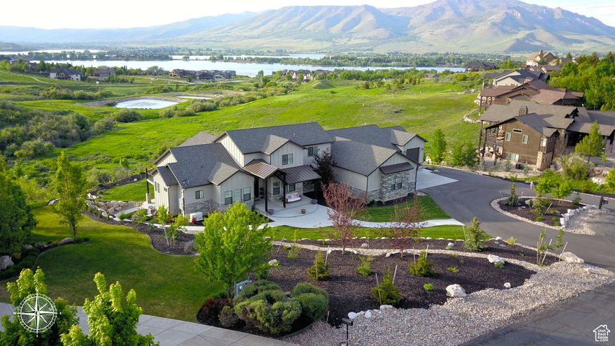 Welcome to this exceptional home in the gated Ski Lake community, perfectly positioned on over an acre with sweeping lake and mountain views. Blending luxury, recreation, and comfort, this 8-bedroom, 7-bathroom home is designed for both everyday living and unforgettable entertaining. The main level features a vaulted great room with a floor-to-ceiling stone fireplace, a gourmet kitchen with quartz finishes and seating for seven, and a charming dining area that opens to a view-filled deck with a built-in grill. The luxurious primary suite includes a spa-like bath, dual vanities, a soaking tub, and a custom walk-in closet. Additional main-level highlights include a walk-in pantry, mudroom, laundry room, and even a built-in slide to the backyard. Upstairs offers two additional bedrooms and a full bath, while the walk-out lower level impresses with 10-foot ceilings, a second family room, kitchenette, bunk room, four more bedrooms, and an indoor basketball/pickleball court. There's also a fitness room, second laundry and mudroom, a playroom with a foam pit and rock wall, and a high-end home theater with a 150" screen and star ceiling. The exterior is equally impressive with heated garages, RV parking, garden beds, a playground, and an in-ground trampoline. Thoughtful upgrades include an automated generator, water softener and custom shutters. Located minutes from world-class skiing, hiking, and biking, this home offers a rare opportunity to experience the best of mountain living.  All property information, boundaries, and documents to be verified by buyer.