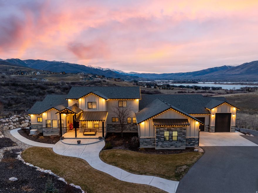 Welcome to this exceptional home in the gated Ski Lake community, perfectly positioned on over an acre with sweeping lake and mountain views. Blending luxury, recreation, and comfort, this 8-bedroom, 7-bathroom home is designed for both everyday living and unforgettable entertaining. The main level features a vaulted great room with a floor-to-ceiling stone fireplace, a gourmet kitchen with quartz finishes and seating for seven, and a charming dining area that opens to a view-filled deck with a built-in grill. The luxurious primary suite includes a spa-like bath, dual vanities, a soaking tub, and a custom walk-in closet. Additional main-level highlights include a walk-in pantry, mudroom, laundry room, and even a built-in slide to the backyard. Upstairs offers two additional bedrooms and a full bath, while the walk-out lower level impresses with 10-foot ceilings, a second family room, kitchenette, bunk room, four more bedrooms, and an indoor basketball/pickleball court. There's also a fitness room, second laundry and mudroom, a playroom with a foam pit and rock wall, and a high-end home theater with a 150" screen and star ceiling. The exterior is equally impressive with heated garages, RV parking, garden beds, a playground, and an in-ground trampoline. Thoughtful upgrades include an automated generator, water softener and custom shutters. Located minutes from world-class skiing, hiking, and biking, this home offers a rare opportunity to experience the best of mountain living.  All property information, boundaries, and documents to be verified by buyer.