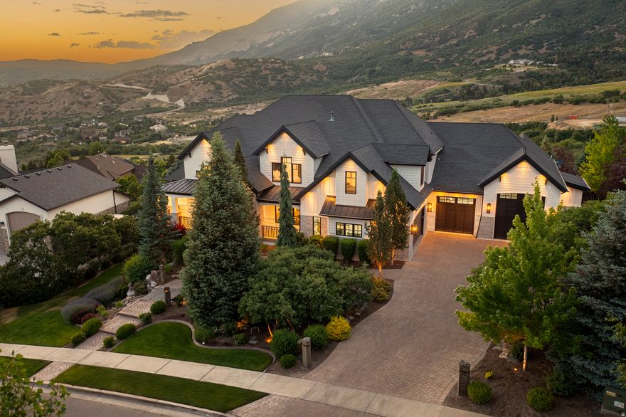 FORMER PARADE OF HOMES' WINNING HOME -  Raykon construction. Homeowner recently spent over $1 million in high-end upgrades. Breathtaking panoramic mountain and valley views with no backyard neighbors. This home offers an elevated lifestyle of comfort, beauty, and effortless entertaining. Step inside to soaring ceilings, luxury glass stair panels, wide-plank wood floors, and custom white oak cabinetry throughout. The designer kitchen stuns with marble countertops, custom finishes, and seamless flow into a reimagined laundry and mudroom. Every room has been elevated - from fresh interior and exterior paint to new lighting, tilework, and a statement stone fireplace. The walkout basement is an entertainer's dream: entertainment bar, open theater, gym, and direct access to the resort-style pool and landscaped yard with mature trees and comes with its own private basketball court. The primary suite is a serene retreat with panoramic views and radiant heated floors. Enjoy quiet luxury with space for everything - including an oversized 7+ car garage with RV/boat parking - with its tall garage doors, you could drive your boat or RV right in. All furnishings are negotiable for a turn-key experience.
