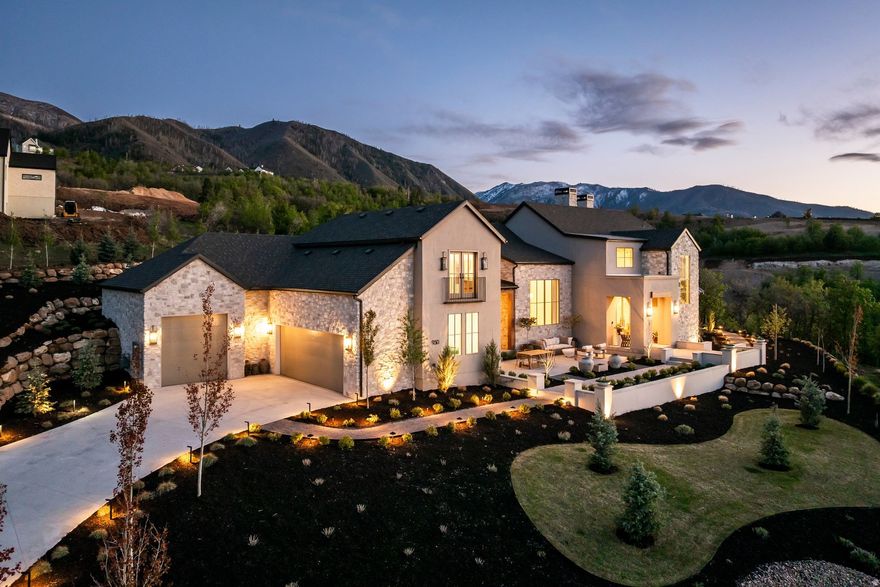 Designed by the award-winning Design Loves Detail and set within Summit Creek's private gated community, this one-of-a-kind custom home delivers 8,400 sq ft of intentional luxury on nearly an acre with sweeping views of Utah Lake, the valley, and the Wasatch Range in every direction.  The main floor opens with vaulted ceilings, floor-to-ceiling windows, and a seamless indoor-outdoor flow anchored by a quartzite kitchen, butler's pantry, and mudroom. The primary suite is its own wing, impeccably finished and quietly removed from the rest of the home. A second main-floor bedroom serves perfectly as a nursery, guest suite or office.  Upstairs, three bedrooms and a loft homework area keep the family spread out without feeling disconnected. The fully finished basement adds two more bedrooms, a home theater, rec room, second kitchen, gym, and laundry. Above the three-car garage, a private mother-in-law apartment with its own entrance adds flexibility that few homes at this price point can match.  Outside, a covered patio, in-ground stainless steel hot tub, and mature landscaping wrap around the home and are designed for entertaining. The whole-home generator, EV charging, and top-tier water filtration system mean nothing has been left to afterthought. Summit Creek HOA amenities include a resort-style pool, clubhouse, pickleball courts, fitness center, and on-site security. A curated furniture and dcor package of pieces selected specifically for this home is negotiable.