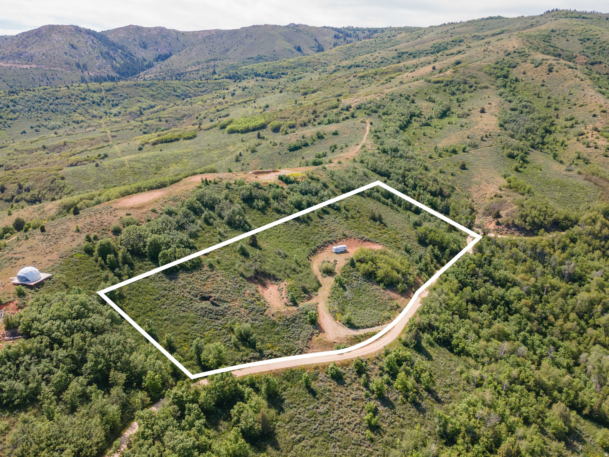 Expansive mountain-side lot with natural landscape