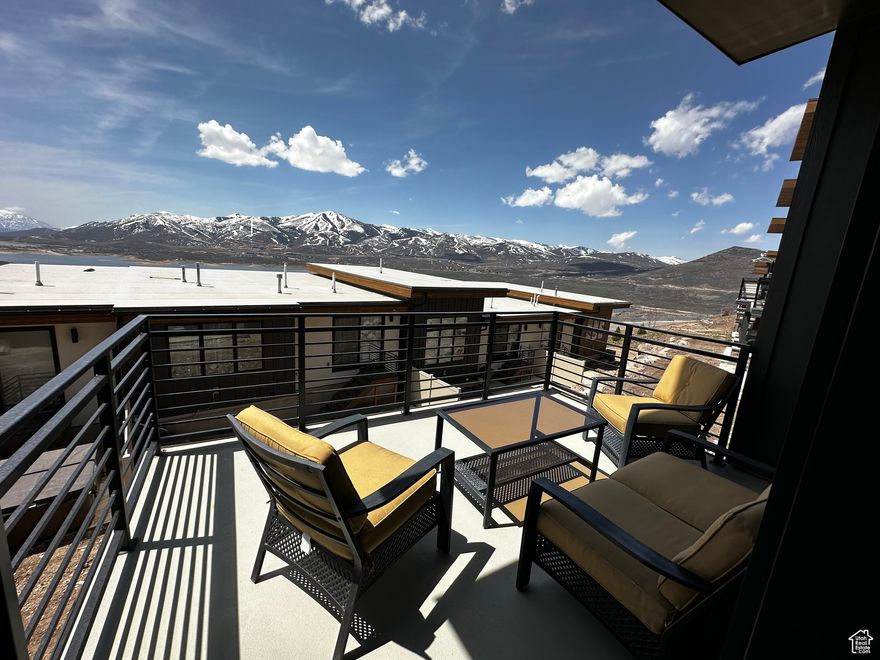 This contemporary townhome overlooks Jordanelle Reservoir and offers a blend of modern comfort and investment opportunity. Featuring wood flooring, quartz countertops, and motorized blinds, the property provides a luxurious yet practical living space. The open-concept living area and fully equipped kitchen are ideal for both personal enjoyment and hosting guests. Multiple decks maximize the stunning views. An attached two-car garage adds convenience, and the allowance of nightly rentals presents a strong income potential. Buyer to verify all information.  The square footage is approximate, sourced from tax data. It is recommended that the buyer obtain an independent measurement to verify all information independently, confirming all property attributes, inclusive of square footage and land extent, to their personal standards.