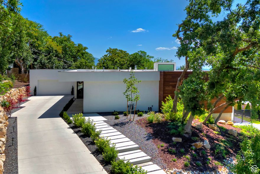 This brand-new, custom-designed home by Sparano + Mooney Architecture offers a rare opportunity to own a stunning one-of-a-kind property in one of Salt Lake City's most desirable neighborhoods. Located in the coveted St. Mary's neighborhood, this recently completed home combines privacy, modern design, and easy access to downtown Salt Lake City, top-rated schools, world class ski resorts, and local amenities. Designed with an emphasis on mostly single-level living, this 4-bedroom, 4.5-bathroom home boasts 10-ft ceilings and expansive living spaces, creating an open and airy atmosphere throughout. The chef's kitchen is outfitted with premium Miele, Wolf, and Sub Zero appliances, seamlessly blending modern style and functionality. Enjoy breathtaking valley views from multiple areas of the home or step outside to your private outdoor living spaces, perfect for both entertaining and relaxation. This home is built to offer the ultimate in comfort and style with a seamless connection between indoor and outdoor living. A spacious 4-car garage provides ample space for parking and storage, completing this home's ideal layout. This is a unique opportunity to own a truly custom, new construction home.