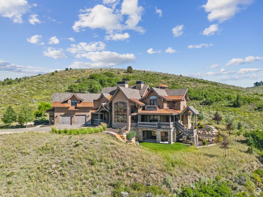 A Timeless Masterpiece in Victory Ranch. Privately perched on 4+ acres, this architectural masterpiece overlooks the renowned Rees Jones-designed golf course. Meticulously crafted by skilled artisans to blend old-world European elegance with modern luxury.  Designed with intention, this Honka home features Pine timber from Finland. The timber construction is natural, sustainable, and free from synthetic insulation. Throughout the home, custom Venetian lighting highlight the exquisite craftsmanship, while Walnut flooring on the main level, cork flooring upstairs offer warmth, and quiet refinement. The living room boasts soaring vaulted ceilings and expansive windows that frame breathtaking views. At its heart is a one-of-a-kind four-sided fireplace adorned with hand-painted designs. The elegant kitchen is a chef's dream, with custom walnut, maple, and glass cabinetry, a walnut countertop with iridescent blue inlay. Adding to its uniqueness is a custom Pechka and pizza oven, hand-built on-site.  The extraordinary library is housed in a stone turret with curved walnut & maple doors and inlaid custom floors. Above it, an observatory serves as the home's crown jewel. Equipped with a telescope & a retractable dome roof. For rest and rejuvenation, over 1000 sq ft home spa awaits. The home features 3 luxurious primary suites, each with scenic views, soaking tubs, glass-enclosed showers, and spacious walk-in closets. The terrace level offers a spacious family room, a custom-designed fitness center, and a private office with its own entrance. Outdoor living is just as impressive, with a covered patio featuring a built-in grill and multiple balconies. A two-car garage and custom dog wash station complete the home. Victory Ranch is a gated community on over 6,250 pristine acres with 4 miles of private Upper Provo River access, offering a lifestyle of unmatched adventure and serenity.