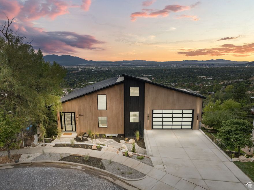 Perched above the city with sweeping views from every level, this 5,557 sq ft modern masterpiece offers 4 levels of luxury living. Featuring 4 bedrooms, 5 bathrooms, and 3 exterior decks, the home seamlessly blends clean design with comfort. Walls of glass frame the entire Salt Lake Valley, while open-concept living, a gourmet kitchen with Allure Quartzite countertops, WOLF and Sub Zero appliances, and a vaulted ceiling primary suite set the stage for refined living. The spacious walk-in closet in the primary suite includes its own in-suite washer and dryer for ultimate convenience and efficiency, and spa-like primary bathroom features radiant heated floors, ensuring warmth and comfort every step of the way. The basement comes complete with a home gym that offers the ultimate wellness retreat, with a steam shower, sauna, and cold plunge to refresh and rejuvenate after every workout. Step outside to the expansive rooftop deck, where panoramic views surround you. This incredible space includes a hot tub, wet bar, and built-in grill area, making it the perfect spot to entertain guests or unwind in privacy while enjoying the serene surroundings. Whether you're relaxing in the hot tub, preparing a meal at the grill, or sipping a glass of wine from your cellar, this home offers the ultimate in luxurious living. This home is new from the inside out (including new electrical and new plumbing) and was completed with a full permit from Salt Lake City, This home is truly one of a kind, do not miss out!  Buyer and buyer's agent to verify all information.  Square footage figures are provided as a courtesy estimate only. Buyer is advised to obtain an independent measurement.