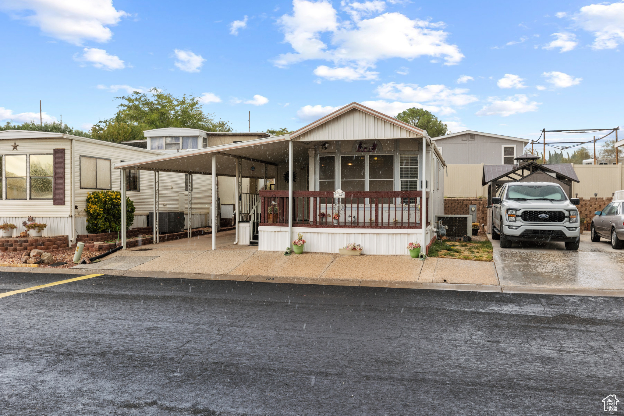 Discover the perfect blend of comfort and convenience in this charming home. Tucked into a welcoming 55+ community, it's just minutes from Costco, Walmart, scenic trails, and peaceful parks, giving you everything you need right at your door. The home itself is in solid shape and needs new carpet (seller offering an allowance) and a touch of TLC, making it a great opportunity to add your personal style. With an extra bedroom for guests or hobbies and an 8x8 storage shed for all your essentials, you'll have plenty of space to stay organized. Step outside to enjoy a spacious wraparound covered deck, ideal for morning coffee, evening visits with friends, or simply soaking in the fresh air year-round. With a little finishing, you can create the cozy retreat you've been waiting for!