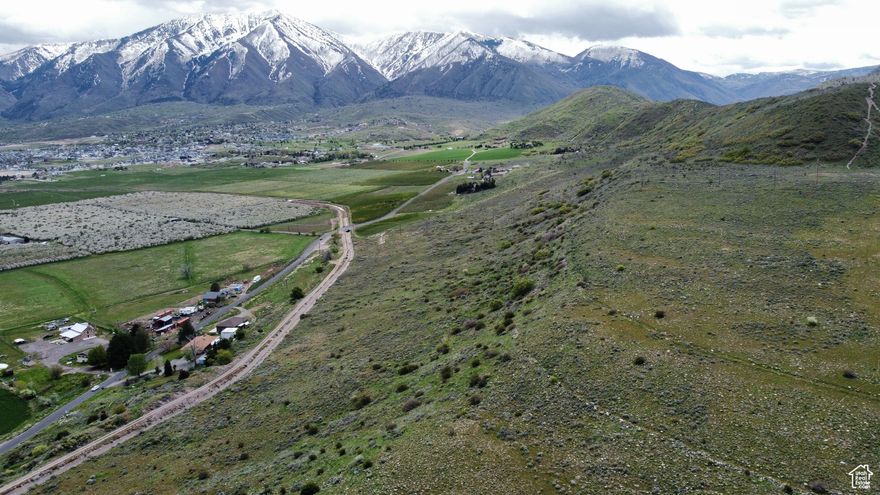 ***Recent land survey shows that this property is larger than what the current county plat map indicates. The property is actually 21 acres and not the 17.82 acres as previously thought.*** This property has some of the best million dollar views in South Utah County. The views face East/Northeast where you can see Salem, Woodland Hills, Elk Ridge and parts of the Gladstan Golf Course. It is surrounded by many orchards that have been there for generations. The land is located on the East side of the "P" on the mountain in Payson. Most of the homes you could put on this property would have amazing views with the ability to have walkout basements because of the slope of the land. The land is located West of the Strawberry Canal and East to the top of Payson Mountain called Rocky Ridge. The current zoning is MH-2. After speaking with Payson City they said it stands for Mountain Hillside. They allow up to 1 dwelling per acre. This means you could have about 12-15+ homes on 1 acre lots with the streets and sidewalks included. You could always try and get the city to change their density to allow for more homes on less land. The property is not landlocked and has access from the property to the West. As for running utilities a shorter distance you could look into tying into current utilities that are on Goosenest, but they would need to be extended. Or you can look into the other canal bridge that someone already installed to the North of the property, but it would require more easements. The utilities are about 1,100' to the North of the property in the street. Payson City just ran power up Goosenest Drive within the last year, so power is now stubbed to the corner of the property. We met with an excavation company out at the property and they said to run utilities to the property and repair the street would be between $400k-$700k (this number was given a couple years ago, but the power had not been run closer to the property either when this estimate was provided). They also said there is plenty of depth in the current sewer line to tap into the existing line. This property has so much potential and with the lot sizes and views it could be an amazing little gem of a neighborhood. Or you can buy it all for yourself to put 1 home on it and have a ranch style property and develop more parcels over time.