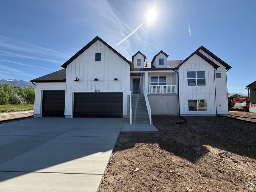 **Ask about our promo worth up to $15,000!**  This stunning rambler in Plain City's sought-after Diamond E neighborhood features vaulted ceilings, a feature fireplace, designer kitchen, and a fully finished basement-perfect for entertaining or extra living space. No HOA, mountain views, and modern finishes make this home a rare find.