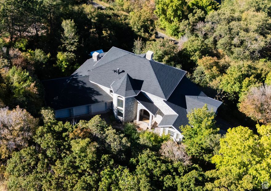 Welcome to this rarely available gem in the coveted Uintah Highlands neighborhood! Newly renovated & move in ready. Perched on the mountain with over 1.5 acres, this well built home offers breathtaking views of the valley, lake & mountains from multiple expansive decks, perfect for entertaining or peaceful reflection. Step inside to soaring ceilings & a spacious, light filled layout. A striking spiral staircase leads to the luxurious upper level master retreat, featuring a gorgeous spa style bath, double walk in closets & an additional living area with views you have to see to believe. The main level boasts a beautifully updated kitchen, formal dining & large living spaces, while the basement includes a bonus apartment with a separate entrance, ideal for guests, rental income, or multi generational living. With a 5-car garage & two driveways for easy access, this home offers ultimate flexibility. Every inch of the property has been crafted with attention to detail and built to last. Located in the heart of Utah & close to parks, trails, schools, shopping, restaurants, Weber State University, Hill Air Force Base & just minutes from world famous ski resorts, this home is the perfect blend of luxury, privacy & convenience. Whether you're seeking adventure or serenity, this dream home has it all!