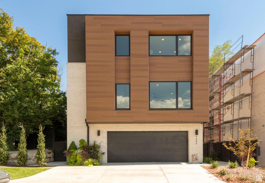 Nestled in the desirable Holladay Park Lane community, this stunning home offers nearly 3,000 sq. ft. of refined living space on a premium end lot for added privacy.  Inside, an open-concept layout features soaring ceilings, wide-plank hardwood floors, and floor-to-ceiling windows that fill the home with natural light. The chef's kitchen impresses with a 12-foot waterfall island, custom cabinetry, a hidden walk-in pantry, and Wolf appliances.  A private elevator ensures easy access to every level. The primary suite includes dual vanities, a large walk-in shower, and a custom closet. The rooftop deck is perfect for entertaining, complete with a built-in Wolf BBQ, fire pit, and panoramic mountain views.  Additional highlights include a two-car garage with hot and cold water, and a lock-and-leave lifestyle with all yard work and snow removal handled by the HOA. Enjoy a private community dog park and walk to Holladay Village, Harmons, and local restaurants. With quick access to downtown, the airport, and world-class ski resorts, this home blends modern luxury with effortless convenience.  Square footage figures are provided as a courtesy estimate only and were obtained from county records.  Buyer is advised to obtain an independent measurement.