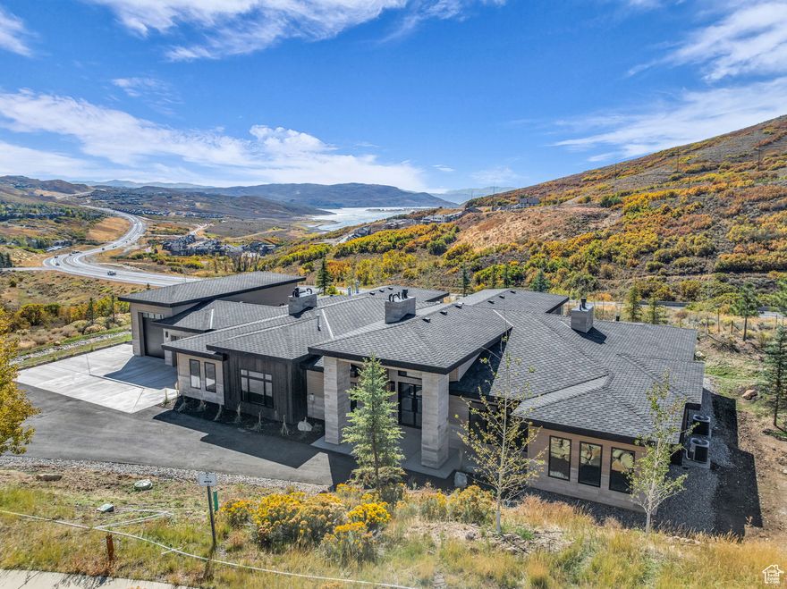 Lake views from this one level Mt contemporary new construction home. Featuring nearly 4500 square, feet the gourmet kitchen offers Thermador appliances, double ovens, a gas range, 2 dishwashers & large pantry. The oversized primary suite offers an additional sitting area with a gym & hot tub just steps away. The generous guest suite & two additional on-suites are perfectly located on the opposite end of the home with a centrally located office off the entry. Plenty of room for toys in the oversized 4 car, 1700s/f garage including space for an RV or boat while the multiple covered patios take advantage of the outdoor setting. Construction by Entrada Homes & Interiors by Intrigue Design.