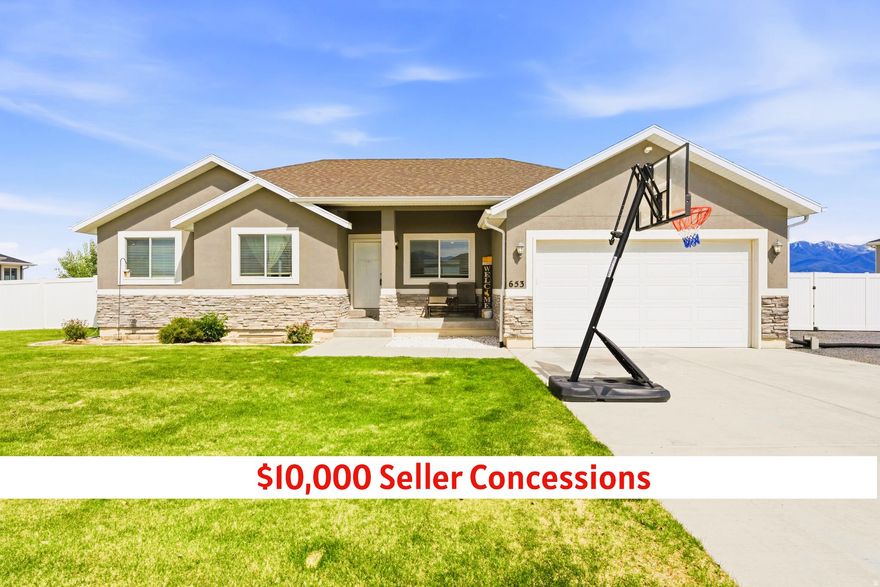 $10,000 in seller concessions offered to be used toward closing costs, rate buy-downs, or updates depending on buyer needs and loan program.  Tucked into the highly sought-after Anderson Ranch subdivision, this beautifully maintained 2017 rambler sits on a fully usable half-acre lot with breathtaking mountain views, no rear neighbors, and the kind of elbow room and flexibility that has become increasingly difficult to find.  From the moment you pull up the curb appeal stands out with manicured landscaping, concrete curbing, mature greenery, and a clean, polished exterior that immediately feels welcoming. Inside the home offers 3 bedrooms, 2 bathrooms, granite countertops, thoughtfully designed spaces, and warm finishes that make the home feel elevated while still comfortable and inviting. Every room feels intentional, cozy, and move-in ready.  The partially finished basement is already approximately 50% completed and currently functions as a playroom and theater space, creating a huge opportunity for instant equity and future expansion. The projector and screen will stay with the home. A basement bathroom has already been partially completed as well, giving buyers a head start on additional finished living space. Whether you envision extra bedrooms, a large family room, gym, office, guest suite, or full entertainment area, much of the groundwork has already been started.  But what truly makes this property special is the lifestyle it offers outside.  Step onto the oversized covered deck and take in the unobstructed mountain views and open space behind the home - a rare level of privacy and breathing room that is becoming increasingly difficult to find. The backyard is peaceful, incredibly usable, and designed for both relaxation and recreation. There is room here to truly make it your own with space for a sport court, pool, outdoor kitchen, garden beds, firepit area, playground, pickleball setup, or future additions without feeling crowded.  The detached 2-car garage/shop is a massive bonus and opens the door for hobbies, projects, storage, business equipment, workout space, or additional vehicle parking. Combined with the extensive RV parking and oversized gravel parking areas, this property was built for people who actually need room for real life.  Bring the RV, trailer, boat, side-by-sides, toys, tools, and trucks. The property has wire run for a 50-amp 240-volt plug, while the current outlet is configured as a 120V 30-amp hookup. There is ample space for additional parking, future outbuildings, or expanded recreational use without sacrificing the clean, polished feel of the property.  Conveniently located just minutes from everyday essentials, the home is less than 15 minutes from Smith's and Walmart, under 5 minutes to nearby elementary schools, and approximately 8 minutes to the junior high and high school. Multiple parks and recreational spaces are also nearby, with three different parks located within roughly 7 minutes of the property offering the perfect balance of quiet, spacious living without sacrificing convenience.    Homes like this strike a rare balance between modern construction, usable land, storage, privacy, and future potential...all while remaining practical for everyday living.  Clean.  Functional.  Peaceful.  Flexible.  Beautifully maintained.  This is the kind of property buyers have been waiting for.