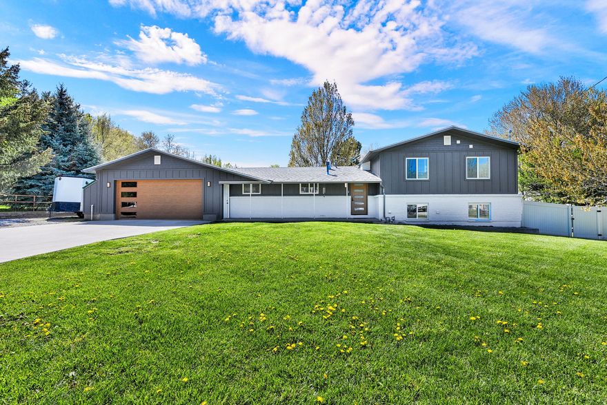 Extensively remodeled and thoughtfully designed, this one-of-a-kind Mantua property offers luxury finishes, mountain views, and space to truly live. Situated on 1.20 acres near Mantua Reservoir, the home features a stunning primary retreat with fireplace, spa-style bath, oversized custom closet/laundry room, and private covered deck with hot tub. The custom kitchen was designed for entertaining and everyday living alike, featuring a hidden butler's pantry with additional appliances, wine cooler, abundant storage, and prep space. Oversized garage/shop space, mature trees, powered office/she shed, and room for animals, hobbies, and recreation complete this exceptional property. Owner/Agent