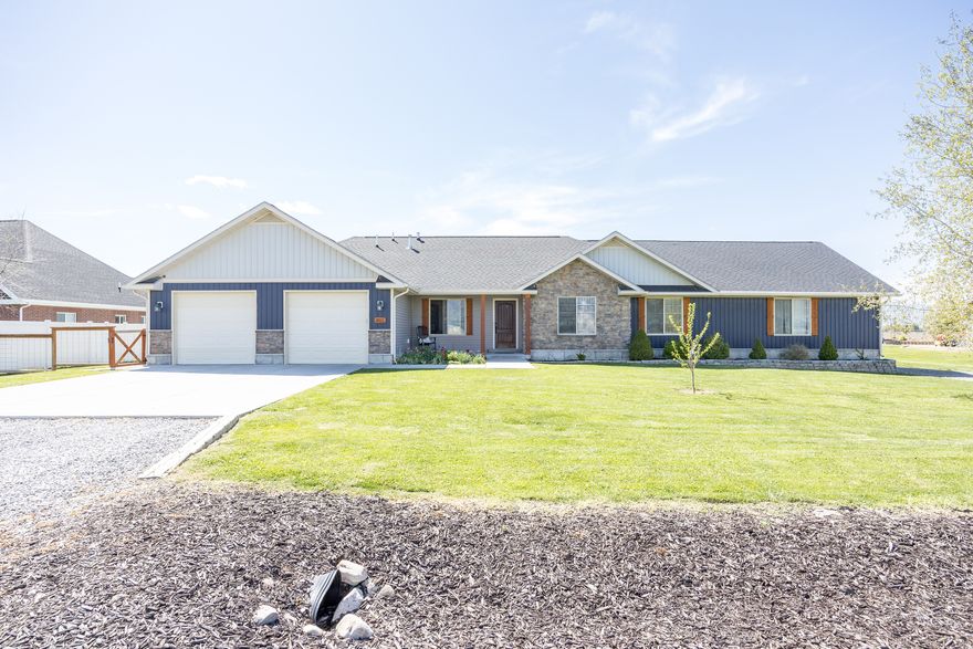 Stunning rambler on a spacious 0.50-acre lot featuring panoramic views of the Wellsville Mountains, East Mountains, and the valley floor in desirable Benson. Enjoy the perfect blend of privacy, scenery, and country living, all just minutes from downtown Logan and Smithfield. Designed with comfort and entertaining in mind, this home offers an open-concept layout with vaulted ceilings and a cozy gas fireplace. The great room and primary bedroom both provide direct access to the back patio, creating seamless indoor-outdoor living-ideal for relaxing mornings or peaceful evenings surrounded by breathtaking views. Additional features include a dedicated workout/exercise room, RV gravel pad, and ample parking with space for up to six vehicles. The 24' x 20' shop includes a 7' x 16' lean-to, with half enclosed on a cement pad, offering versatile storage or workspace options. The fully landscaped yard is equipped with an automatic sprinkler system. Please schedule all showings through Aligned Showings and allow at least 2 hours' notice. A Supra lockbox is located on the garage door. Kindly text one or both agents with intended showing times. Please allow 48 hours for offer responses and include all addenda. All measurements are provided as a courtesy from building plans and should be independently verified by the buyer and buyer's agent.