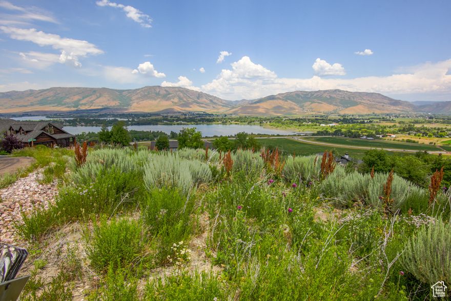 Important to note! Lot has water hookup already acquired with payments being made monthly for standby service. This is an outstanding lot in prestigious gated community with endless views! Corner location gives directional choice of placement. Seller also has architectural home plan designed to suit lot available to buyer. Every kind of year-round outdoor pastimes within minutes. Backs onto Snow Basin property with Powder Mountain, Nordic Valley Ski resorts close by, and Pine View Reservoir in view. Gated community requires access code so please call to view. Included here is the link to HOA website, video and info: https://www.summitatskilake.com/