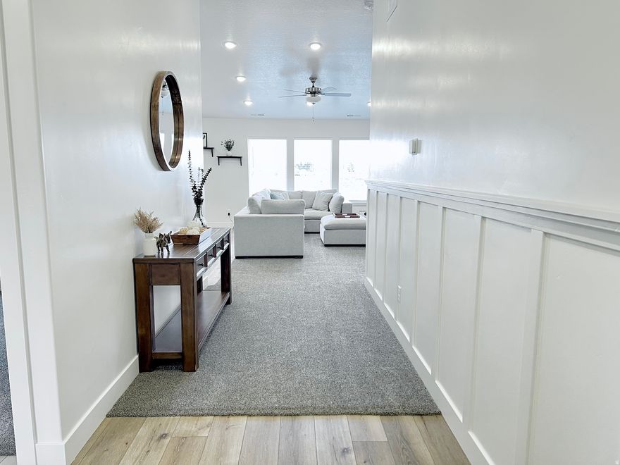 Welcome to this beautifully finished single-level rambler in the desirable Nibley Farms Community. Built in 2024, this 3-bedroom, 2-bath home offers 1,390 sqft of thoughtfully designed living space with an open-concept layout, vaulted ceilings and abundant natural light. The home features quartz countertops throughout, adding a bright modern, durable finish to the kitchen, bathrooms, and window ledges. The primary suite includes a walk-in closet and private bathroom, while the additional bedrooms provide comfortable space for family, guests, or a home office.  Step outside to enjoy fully completed landscaping with an automatic sprinkler system, saving you time and expense while giving the home instant curb appeal. The property also features a 2-car attached garage, RV parking, and a flat lot located in a quiet cul-de-sac with beautiful mountain views.  Conveniently located near parks, walking trails, and open space, this home offers the perfect blend of modern comfort and peaceful neighborhood living.