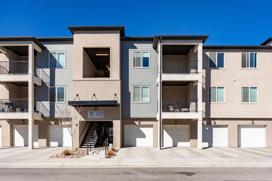 This stunning 2023-built top-level condo delivers modern design with upgraded lighting, vaulted ceilings, and a bright open-concept layout that feels anything but ordinary. Quartz counters, stainless appliances, and a private patio make everyday living feel elevated. Three bedrooms, two baths, a large laundry room, and a private garage complete the package. Community amenities include a pool, clubhouse, gym, and pickleball courts. Minutes from Mountain View Village and quick access to Mountain View Corridor and Bangerter Highway. Lock-and-leave luxury at its best.