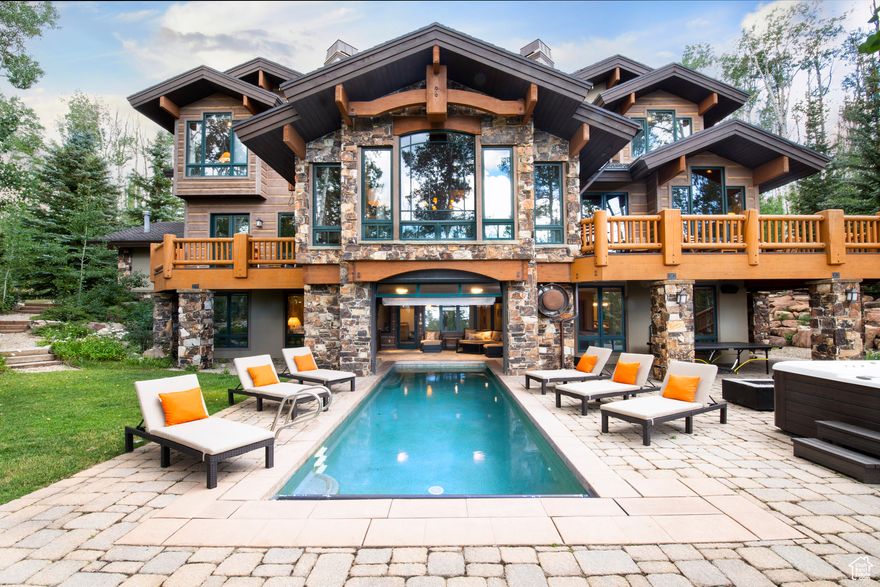 Welcome to your new Colony Ski Retreat-one of the premier properties in Park City! Located in the exclusive community of The Colony at White Pine Canyon, this  home offers unmatched ski-in/ski-out access at Park City Mountain's Canyons Village. Renowned for its privacy, seclusion, and sweeping mountain and valley views, The Colony is one of the most sought-after neighborhoods in the area. Thoughtfully designed as a multi-family or executive retreat. The upper level features two luxurious master suites, as well as two additional en-suite bedrooms upstairs, totally 4 bedrooms upstairs.  The main level is dedicated to entertaining, with large gathering areas that include a gourmet kitchen and breakfast nook, formal dining room, spacious family room, and elegant living room. A state-of-the-art media room with a wet bar and two separate two-car garages add to the home's impressive amenities. Step out onto the expansive deck and take in breathtaking down-valley views over Park City. The lower level offers direct ski access, complete with a ski prep room, individual lockers, and boot warmers. One of the standout features of this retreat is the stunning indoor/outdoor heated pool, perfect for relaxing aprs-ski. This level also includes an additional five bedrooms, ensuring ample space for guests. Don't miss this rare opportunity to own a one-of-a-kind alpine retreat. Call today to schedule your private tour.