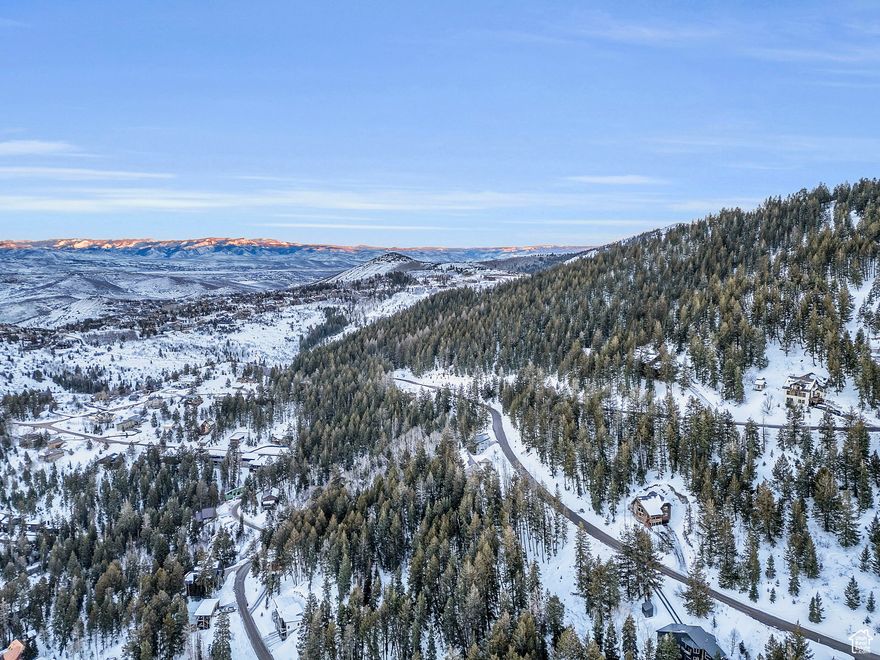 ''Between every two pines is a doorway to a new world.'' John Muir Build your doorway here in Summit Park where you will find seclusion amidst the trees and serene mountain views ... where you can feel a world away from the chaos yet be just minutes to the wonderful amenities of Park City and just 30 minutes to Salt Lake City. This unique lot can actually be an uphill or a downhill build with road frontage on two sides. See attached survey and concept drawings. Preliminary plans for a cosy A-frame home are included. Or there is plenty of space for your own design. Summit Park is a haven for fresh air, year round mountain lifestyle and recreation. Local hiking, mountain biking and snow shoe trails abound along with back country skiing. Not to mention your are 15 - 20 minutes to Park City and Deer Valley and Woodward Ski resorts and Main Street.
