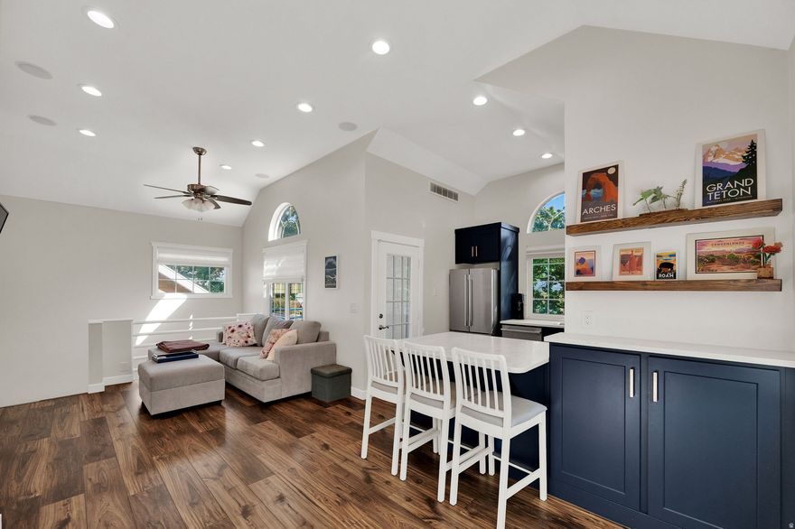 PRICE REDUCTION! Welcome to the best-kept secret in Taylorsville! This beautifully updated 2-bed, 1-bath end unit sits quietly at the back of the community, offering extra privacy and serene mountain views from the kitchen, family room and private balcony. Step inside to soaring vaulted ceilings and abundant natural light that make the space feel bright and open. The modern kitchen features rich navy cabinetry, white quartz countertops, and stylish bronze hardware, perfectly paired with warm laminate wood flooring throughout the main living areas. A cozy gas fireplace anchors the living room for relaxing nights in. Enjoy the convenience of an attached garage with direct interior access. The well-maintained HOA covers all landscaping and snow removal, and residents love the resort-style amenities including a pool, tennis court, game room, hot tub and racquetball court. Located in a prime central area with quick access to both I-215 and I-15, you'll be just 15 minutes to downtown Salt Lake City and 30 minutes to world-class mountain recreation. Come experience the perfect balance of comfort, convenience and community; this light-filled condo is a rare find and truly one of the best in the complex. Square footage figures are provided as a courtesy estimate only and were obtained from county records. Buyer is advised to obtain an independent measurement.