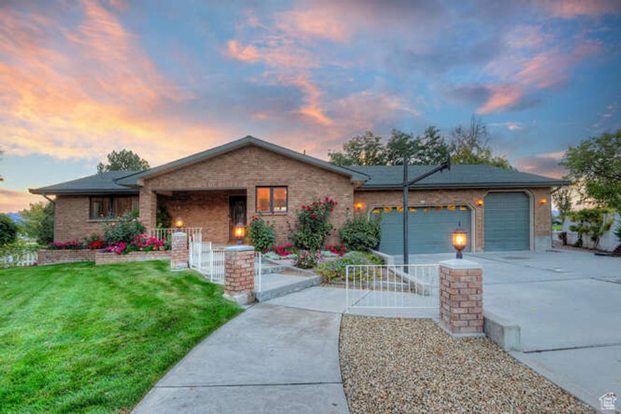 Welcome to 219 Country Club Drive in Stansbury Park-a solidly built rambler tucked away on a quiet cul-de-sac and backing the beautiful Stansbury Golf Course. This timeless home was designed to last, with a full brick exterior framed by a meticulously maintained lawn. Step inside to discover hardwood floors, new carpet in much of the home, wood-framed windows, and generously sized rooms with multiple gathering spaces. Enjoy both main-floor and basement family rooms-perfect for entertaining. From the walk-out basement you'll catch stunning sunsets, or take in the views from the covered porch just off the main-floor family room. Storage abounds both inside and out, but the garage is where this home truly shines. The heated garage offers a tandem bay with extra height, plus just a few steps up you'll find an oversized workshop-ideal as a mechanic's space, woodshop, man cave, she shed, or hobby room. For even more convenience, the property also includes a ground-level golf cart garage that can double as extra storage or flex space for your needs. This home is as practical as it is inviting, combining lasting construction with spaces for work, play, and relaxation-all in a premier golf course location.  Square footage figures are provided as a courtesy estimate only. Buyer is advised to obtain an independent measurement.