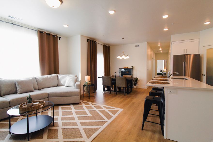 Beautifully maintained 1258 sq ft condo in the heart of American Fork! This inviting unit features an open-concept layout with abundant natural light, creating a warm and welcoming atmosphere. The kitchen offers ample cabinet space and flows seamlessly into the living and dining areas, perfect for everyday living or entertaining. 3 Spacious bedrooms and 2 bathrooms provide comfort and functionality. Enjoy resort-style HOA amenities including a pool, parks, pickleball courts, and scenic walking paths. The HOA also covers water, sewer, trash, and snow removal, making for easy, low-maintenance living. Conveniently located near American Fork shopping, dining, parks, and easy freeway access. Ideal for first-time buyers, investors, or anyone seeking low-maintenance living! Buyers agent to verify information. Option to purchase with furniture!