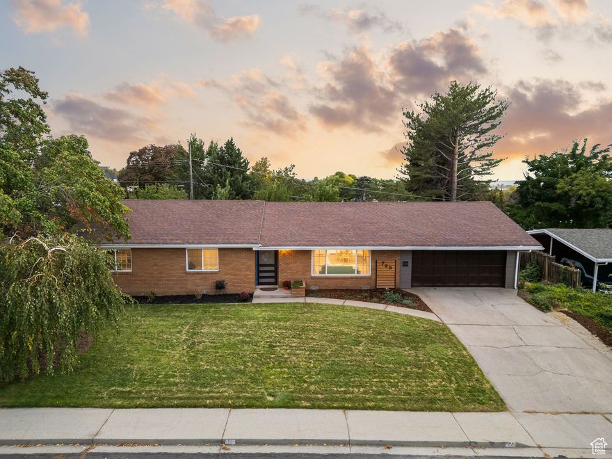 Rare find in one of Orem's most convenient locations. This beautifully remodeled single-level home offers modern comfort and style with sweeping views of Utah Lake and the valley. Fully renovated in 2022, it features an open-concept layout with updated flooring, lighting, and fixtures throughout. The kitchen includes sleek cabinetry, solid-surface counters, and stainless steel appliances, seamlessly connecting to spacious living and dining areas ideal for entertaining. The home's thoughtful updates continue with a new tankless water heater, updated HVAC, and efficient systems for year-round comfort. The primary suite provides ample space, natural light and an upgraded en suite bath with granite counters, while the secondary bedrooms and guest bath maintain the same attention to detail. Outside, the professionally landscaped yard offers a peaceful retreat with mature trees, manicured gardens, and stunning sunset views over the lake. With close proximity to UVU, major commuter routes, and shopping, this property perfectly blends convenience, functionality, and refined single-level living.