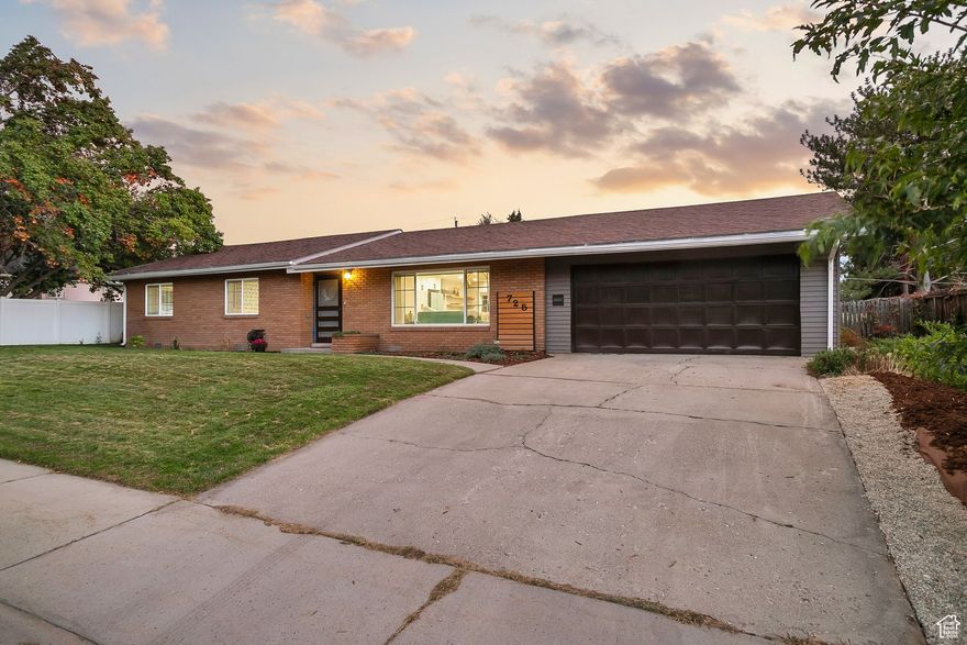 Rare opportunity! Sunset Vista Subdivision is a historic, peaceful neighborhood known for impeccably maintained properties. Enjoy the ease and accessibility of one-level living in this solid, Mid-Century Modern brick ranch home. Spacious, open floor plan, ample storage, sustainable hardwoods, and picture windows. Traditional on the outside and modern on the inside, the entire home has been renovated to include a bright, open kitchen with high end appliances, powered storage island, deep double sink, soft-close drawers, and gorgeous mother of pearl concrete counters. The guest room sits across from the fully equipped laundry room, with tons of storage. Endless hot water from the energy efficient tankless water heater. Guest bath with classic tile and deep soaking tub. Plentiful storage with entry, utility, and 2 linen closets. Spacious third bedroom with lovely light from large windows. Oversized primary bedroom with custom walk-in closet, en suite with walk-in rain shower, vanity and bidet! New furnace, A/C, oversized 2 car garage with attached workshop, and relaxing spacious covered patio. Located on the crest of the hill, the expansive, fully fenced, well-maintained yard boasts breathtaking lake sunsets, valley and mountain views. Enjoy nature's bounty from 12 mature fruit trees. New smart home features allow easy control over the modern safety and security systems, lights, locks, temp, appliances and more. A stones throw from UVU, top rated schools, shopping, dining and on ramps. 1-0 Buydown with Preferred Lender! Don't miss your chance to make lasting memories in this ideal home.