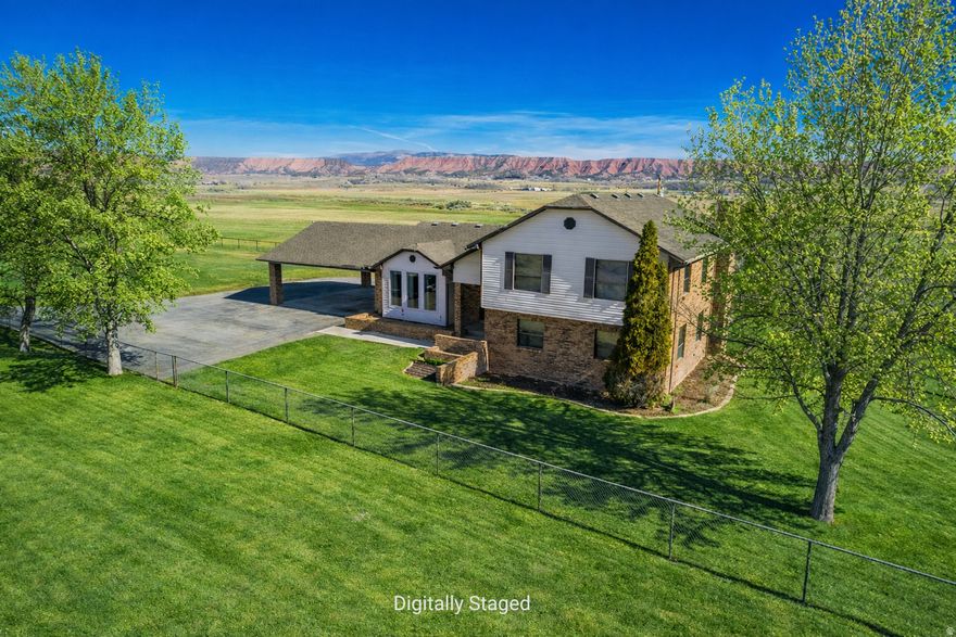 Bring your critters, humans, and all your big toys...this place offers space, privacy, and land close to Vernal or Roosevelt! With five-bedrooms and 3.5 baths, this home in Tridell offers multiple living areas, GEO-THERMAL heating, granite countertops, and a fully finished basement with walkout access. Recent updates include a new roof and septic leach lines in 2018, a new water heater in 2019, new stove, and microwave in 2020, a new furnace and central air in 2021, and new flooring in the primary suite in 2026. The spacious property features a fully fenced yard, and one share of White Rocks water to keep everything lush. Additional highlights include RV parking and a 27x30 shop with 220 power, heat, air conditioning, and an automatic garage door. Plus another 10x16 shed with power to it.  With 1.37 acres - unlimited possibilities are waiting for just the right people to call this place home.  Info. deemed reliable, buyer to verify sqaure footage.