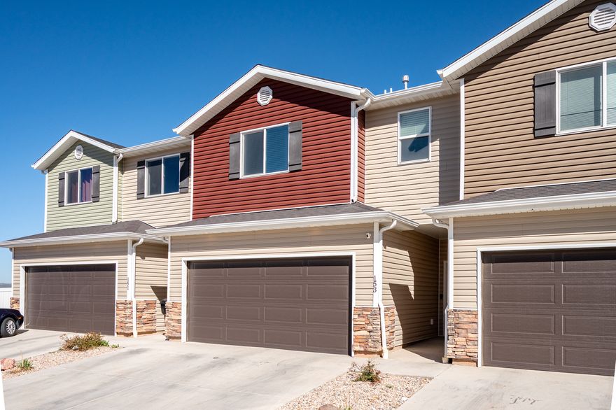 This inviting 3 bedroom, 2 bathroom Cedar Bend townhome--with its own private outdoor sauna and security system--offers the perfect mix of comfort, style, and standout extras. Ideally located next to visitor parking, it also features peaceful, open views out back with no rear neighbors. The open concept main floor seamlessly connects the kitchen, dining, and living areas, creating a bright and welcoming space that's perfect for entertaining. The kitchen showcases white cabinetry, solid surface countertops, and a spacious pantry. Upstairs, you'll find three bedrooms, two full bathrooms, and a conveniently located laundry area, including a new LG Smart stackable washer and dryer. Step outside to a fully fenced, low maintenance turf backyard and unwind in your own private sauna retreat.