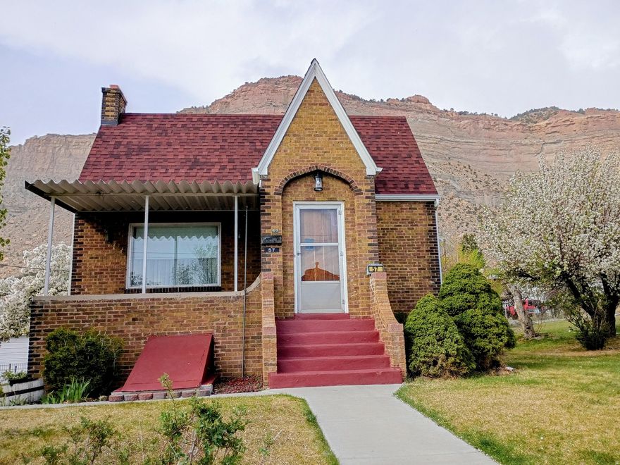 HUGE PRICE REDUCTION ON THIS SPACIOUS 4 BEDROOM BRICK HOME IN HISTORIC HELPER! Schedule a tour to see this Tudor-style home with over 3,600 square feet. Also, includes 3.5 water shares through the Spring Glen Canal Company. This property offers the perfect blend of privacy and conveniently located a short distance from downtown Helper. The main level of this charming home features two bedrooms and a full bathroom along with built-In storage in the hallway. Additional storage can be found in each bedroom closet, ensuring ample space for all your belongings. Entertain guests in the formal living room, which provides plenty of space for family and friends. The formal dining room is large enough for family gatherings. The eat-in kitchen is a cozy spot for casual meals, equipped with a large walk-in pantry and newer appliances, making it a practical and inviting space for cooking and dining. The expansive family room addition features real hardwood flooring and a stunning rock fireplace with a woodstove insert, ideal for those cooler evenings. With large picture windows in the living and dining rooms, the main level is bathed in natural light, creating a warm and inviting atmosphere. The basement offers 2 additional bedrooms and a 3/4 bathroom with a corner shower with natural light. Relax on the patio and soak in the peaceful surroundings of Helper while appreciating the nearby beautiful red rock mountains. Enjoy the view of the famous balanced rock sitting on top of the mountain nearby. The property is home to an apricot tree, apple tree and walnut tree, adding to its charm. A manual sprinkler system helps maintain the lush greenery surrounding the home. The detached two-car garage provides plenty of storage space, ideal for vehicles and outdoor equipment. The home features several updates, including a newer roof and siding on the family room. Tax ID: 1A-1082-0000 is included in the sale. Conveniently located near ATV trails, the Helper River walkway and a vibrant arts community. Perfect home for those who love outdoor adventures and cultural events in Helper throughout the year. Square footage figures are provided as a courtesy estimate only and were obtained from the Carbon County Tax Records. Buyers are advised to obtain an independent measurement for accuracy.