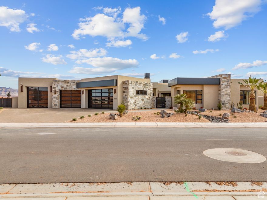 Luxury Living at The Estates at Sand Hollow Resort  Welcome to your private desert oasis in The Estates at Sand Hollow Resort, a premier neighborhood of luxury homes set against one of Southern Utah's most breathtaking backdrops. Situated on a .41-acre lot that backs to a scenic walking path, this 4,312 sq. ft. residence by Utah Oasis Homes, Inc. captures panoramic views of Pine Valley, Zion National Park, and beyond.  Designed with an open-concept floor plan, the home seamlessly blends indoor and outdoor living through expansive multi-slide dining windows. The gourmet kitchen features Thermador appliances, a gas stove, and quartz countertops throughout, perfect for both everyday luxury and entertaining.  Step outside to a resort-style backyard complete with a 20x40 extra-deep pool and jumping platform, hot tub, in-ground trampoline, outdoor shower, and an outdoor kitchen with BBQ, fridge, sink, quartz counters, and cooling misters. A front courtyard with fireplace welcomes guests, while multiple fire features add ambiance to your evenings.  Additional highlights include an attached casita with private access, Sonos surround sound, automatic blinds, Moen fixtures, Andersen windows, porcelain flooring, extra-wide hallways, and an epoxy-coated 5-car garage-ideal for cars, golf carts, and ATVs.  Homeownership in The Estates means more than just a home-it's a lifestyle. Enjoy direct access to the nationally ranked Sand Hollow Championship Golf Course, world-class boating and paddleboarding at Sand Hollow State Park, and the adventure of Sand Mountain sand dunes, where you can ride your ATV straight from your garage. Here, privacy and scenery combine with luxury amenities to deliver a one-of-a-kind retreat.  Furniture package available.