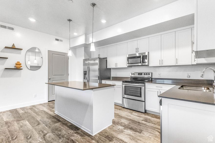 Discover the epitome of contemporary living in this stunning modern condo featuring two bedrooms with new carpet and two bathrooms. This stylish residence boasts an open-concept layout, allowing natural light to flood the living area, creating an inviting atmosphere perfect for relaxation or entertaining. The gourmet kitchen is equipped with stainless appliances, soft close cabinets & drawers, and sleek countertops, ideal for culinary enthusiasts. Enjoy the convenience of in-unit laundry, ample storage, and private balcony. Bonus: sellers are including the sectional, washer, dryer, and fridge. Located in a vibrant neighborhood with easy access to shopping, dining, I-15 and HAFB.  this condo is perfect for those seeking a blend of luxury and urban lifestyle. Don't miss your chance to call this beautiful space home!