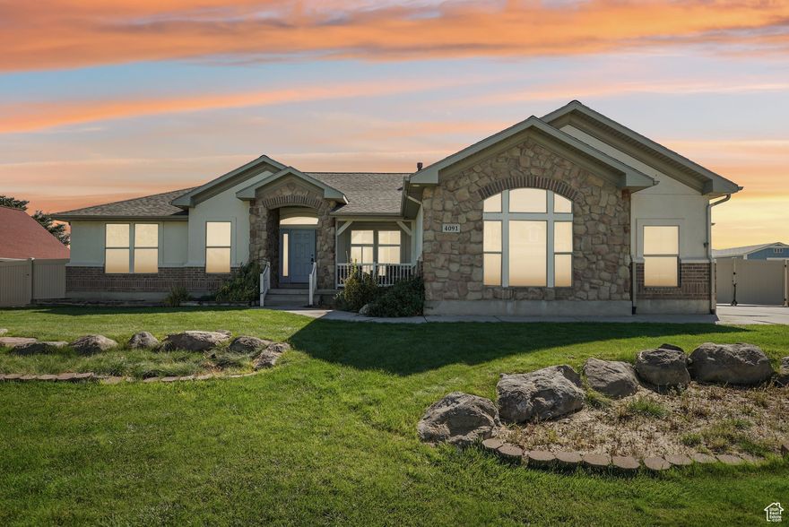 Welcome to your own private retreat with room for everyone-this spacious 4,121 sqft home sits on a beautifully landscaped half-acre with no backyard neighbors and breathtaking mountain views. The main level offers 3 bedrooms, 2 baths, a dedicated office, a cozy family room, and a large remodeled kitchen perfect for gathering and entertaining. Downstairs, a fully equipped mother-in-law apartment with a separate entrance features 3 additional bedrooms, 1 bath, its own kitchen, laundry, and plenty of space for guests, extended family, or rental income. The oversized 3-car heated garage includes a built-in sink, and there's ample parking for all your vehicles and toys. Enjoy evenings on the covered patio while watching sheep graze in the open field beyond. The yard is a gardener's dream with raised beds, multiple fruit trees, and secondary water for efficient yard care. Inside, the large primary suite boasts an extended bathroom and an enormous walk-in closet. With 2 washers, 2 dryers, 2 refrigerators (all included), and a brand-new HVAC system, a new roof, this home is move-in ready and made for comfortable, multi-generational living.