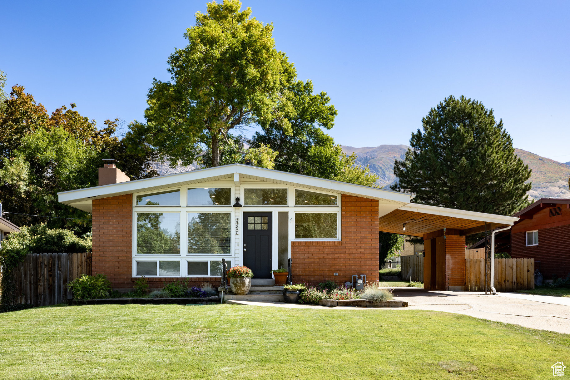 Charming Brick Rambler with Mother-in-Law Apartment in Ogden. This well-cared-for raised rambler featuring 2,296 sq. ft. of comfortable living space. Situated on a private lot directly across from an elementary school, this home offers both convenience and privacy located just minutes from Weber State University. The main level includes 3 bedrooms and 2 bathrooms, with thoughtful updates throughout, including refreshed bathrooms, new flooring, and modern paint. A warm brick exterior adds timeless character, while large windows invite natural light into the open living areas. Downstairs, you'll find a full second kitchen, 2 additional bedrooms, and 1 full bathroom-perfect for a mother-in-law setup, extended family, or rental potential. The home has some outstanding updates over the years, new windows, converted to central air, and a new roof and water heater have been installed this year.