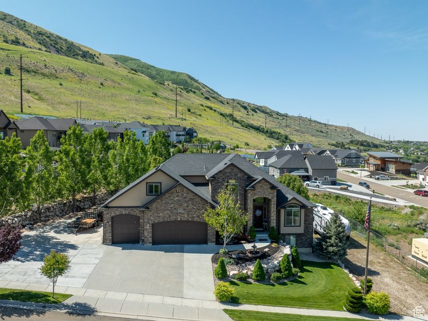 Absolutely beautiful home with spectacular views in every direction! From the mountains to a complete view of the city with the Brigham City Temple, as well as far as you can see and to Willard Bay. The heated shop is constructed of steel and measures 34X34. RV hookups on the property. The basement is nearly finished with 9ft ceilings through out. Large gorgeous kitchen, beautiful finishes through out and lots of natural light. The bonus room makes for a great office or hang out space. The trees in the Spring create perfect privacy and shade in the backyard and the peach orchard across the street is beautiful in bloom!  Check out the video tour for a birds eye view.